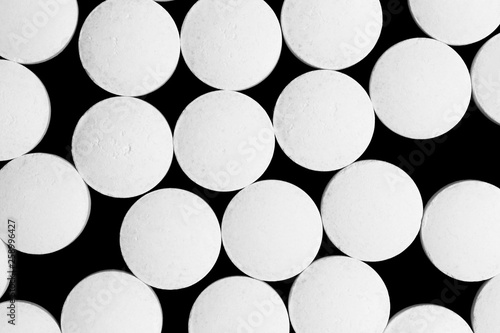 White round tablets pills isolated on black background