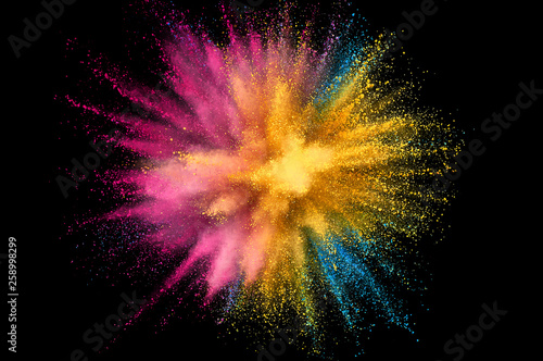 Colored powder explosion. Abstract closeup dust on backdrop. Colorful explode. Paint holi