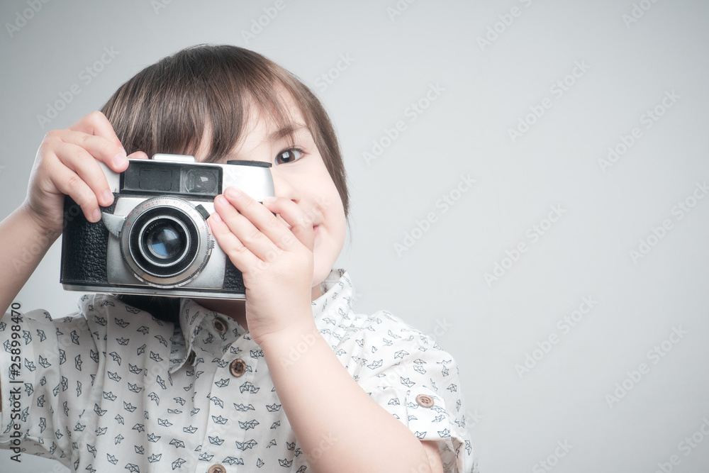 Kid with old photo camera	