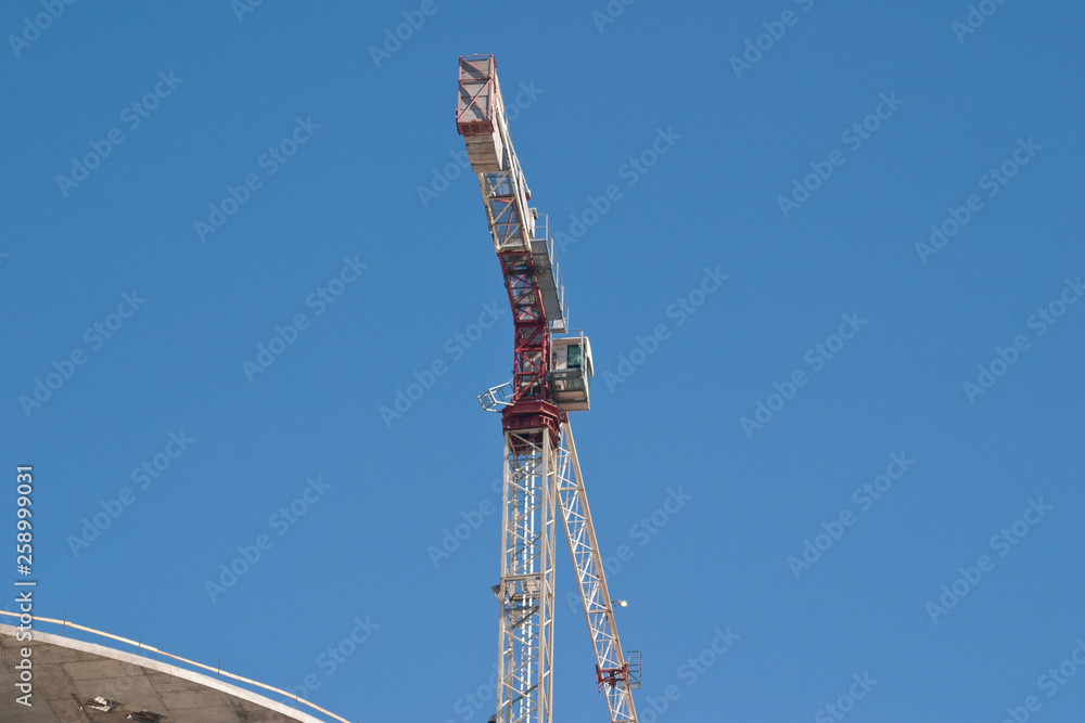 Obraz premium Image of tower crane on blue sky background