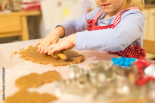 Baking with the family - Mother and daughter making self made cookies in a home kitchen