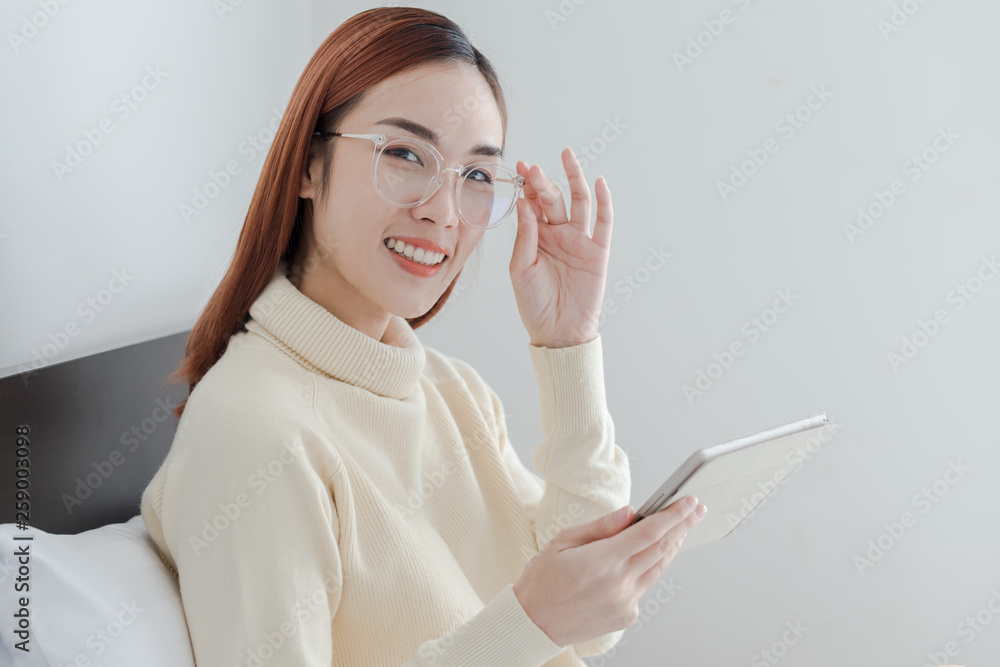 Attractive happy business woman using computer tablet for check her online shopping and smile Attractive happy business woman using computer tablet for check her online shopping and smile
