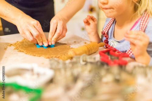 Baking with the family - Mother and daughter making self made cookies in a home kitchen