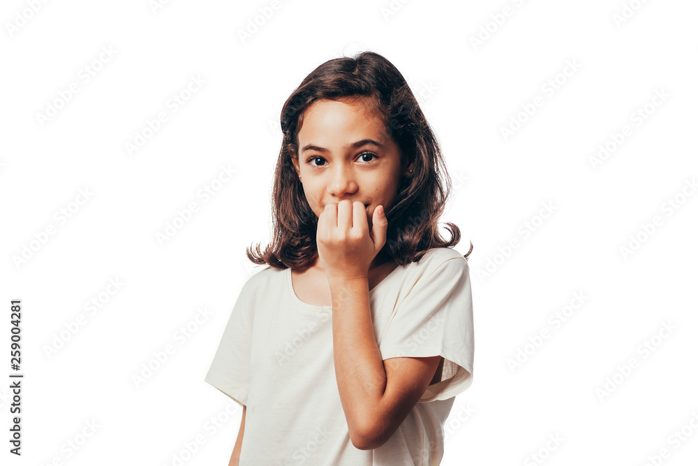 Portrait of young girl biting her nails on white background Portrait of young girl biting her nails on white background