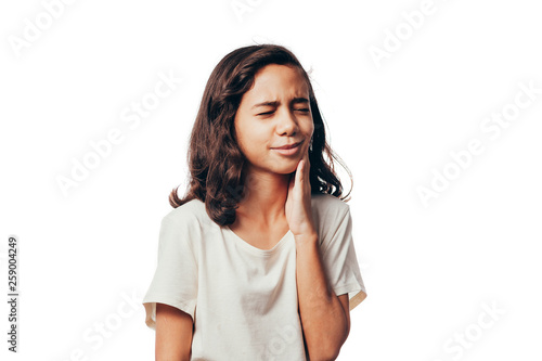 Portrait of young girl suffering with toothache on white background © kleberpicui