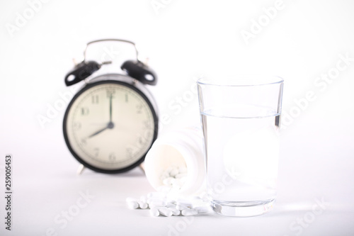 water pill watch lying on a white background photo