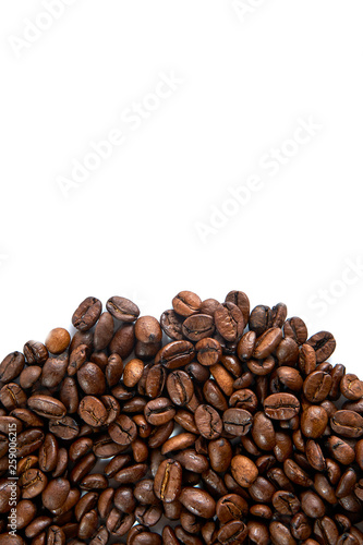 Coffee grains scattered on a white background with a place for an inscription.