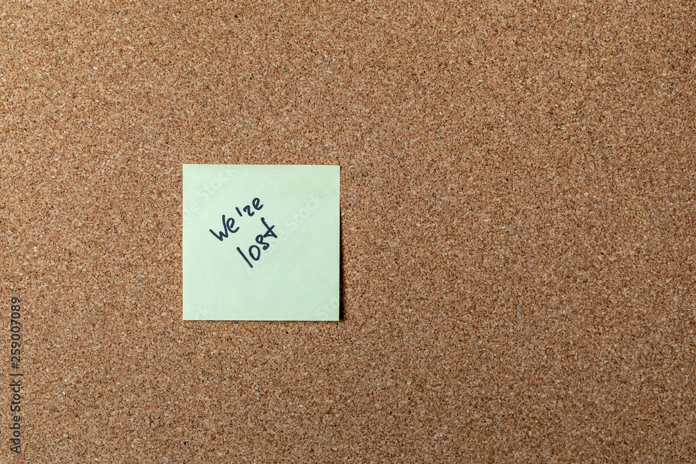 green sticker on brown table. color sticker, motivational, quote, and words, note, message we're lost green sticker on brown table. color sticker, motivational, quote, and words, note, message we're lost