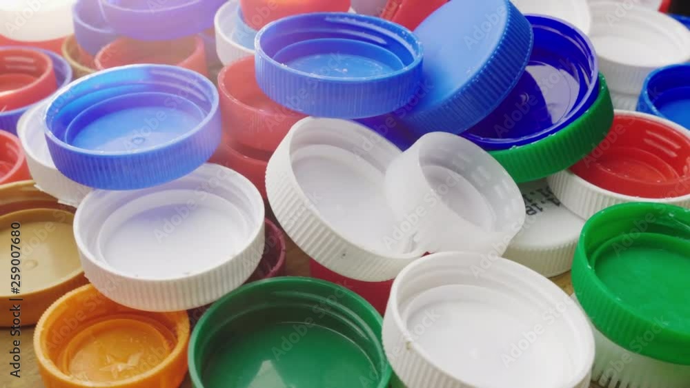 Many plastic bottle caps. Recyclable and recyclable plastic waste concept Many plastic bottle caps. Recyclable and recyclable plastic waste concept