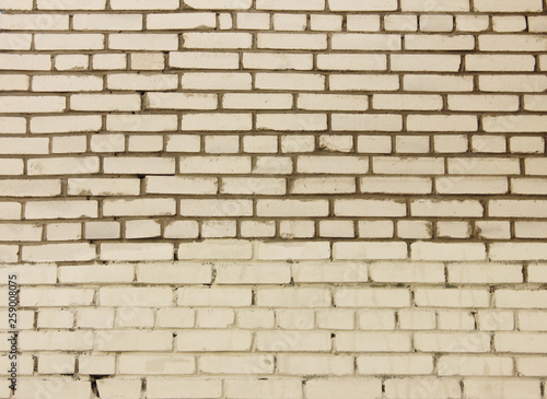 White brickwork background. Empty masonry produced by a bricklayer with bricks and mortar in brick wall structure. Brick courses of different size blank rough texture