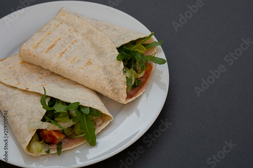 Healthy avocado and vegetables burrito, wraps, rolles. Healthy breakfast or snack. Avocado sandwich. Copy space.