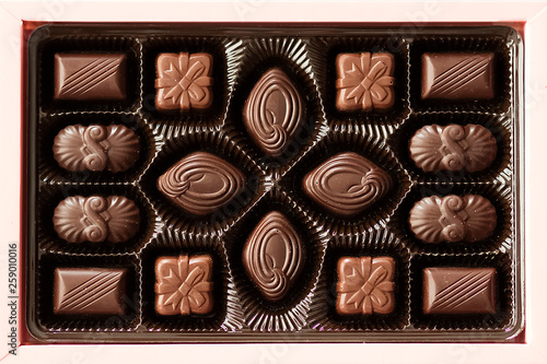 Box of chocolate candies on gray background. © zhannaz