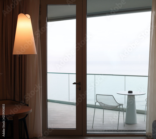 Living room with glass door to balcony. Sea view. photo