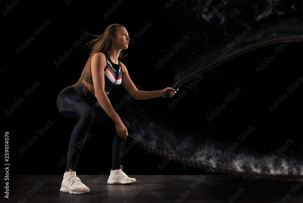 Woman working out with battle ropes