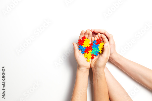 Wallpaper Mural Hands holding colorful heart on white background. World autism awareness day concept Torontodigital.ca
