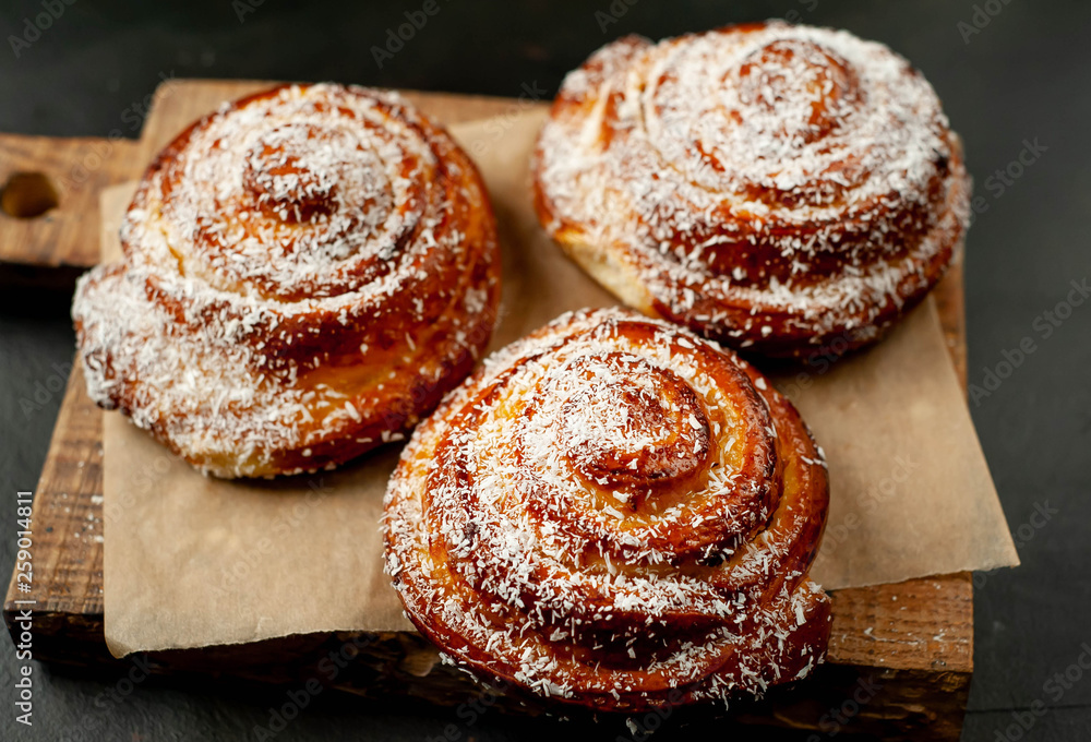 buns with pineapple filling on a cutting board on a background of concrete,Kanelbule - swedish dessert