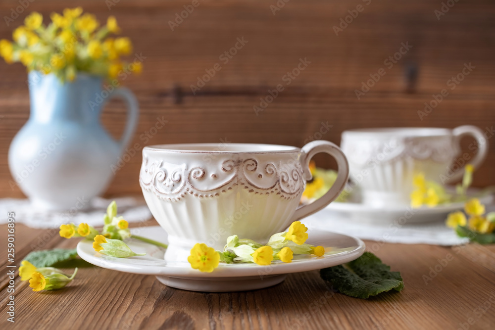 A cup of herbal tea with wild primula flowers A cup of herbal tea with wild primula flowers