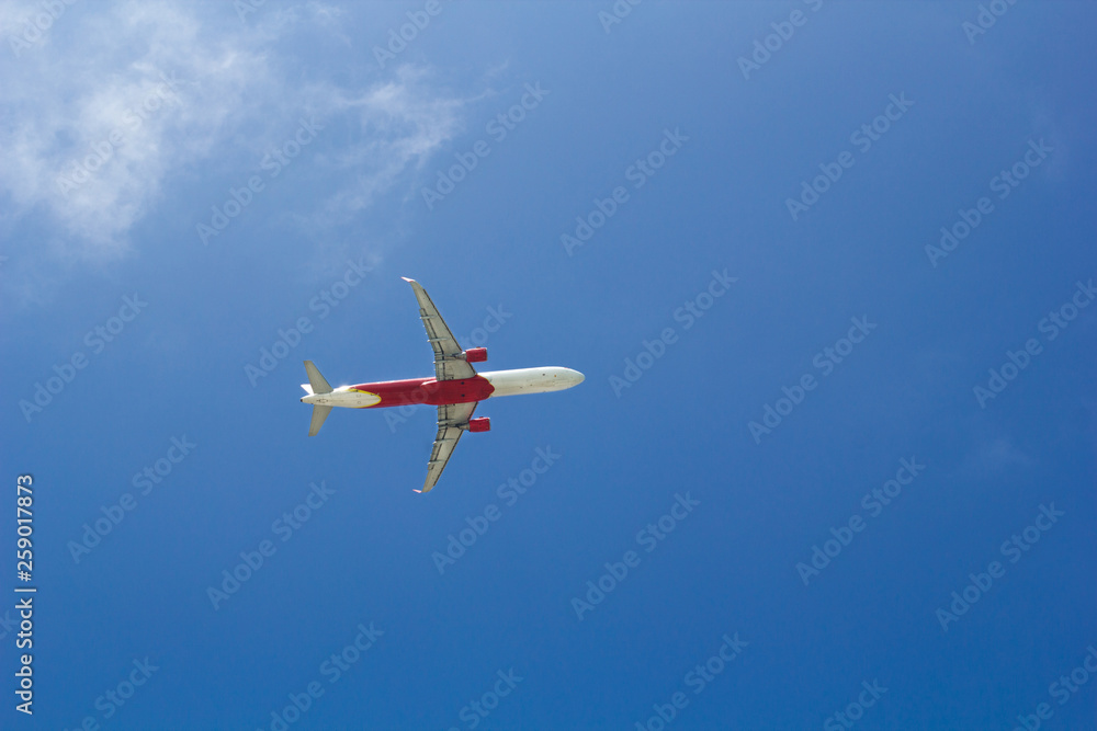 Passenger plane flying in the blue sunny sky Passenger plane flying in the blue sunny sky