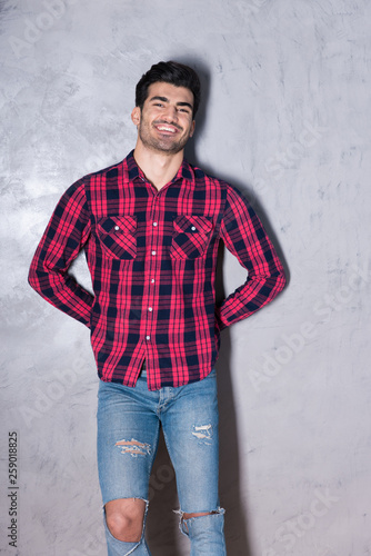 A happy young man in a red checkered shirt © Spectral-Design