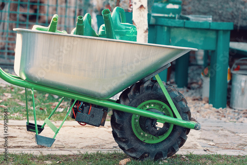 Tableau sur Toile electrify powered motorized garden wheelbarrow with garden watering can