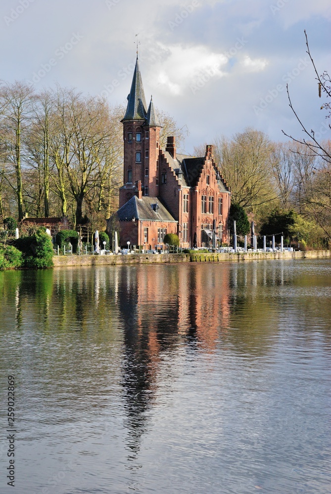 Medieval Minnewater Castle seen from the Minnewater Lake (Lake of Love) in Bruges, Belgium Medieval Minnewater Castle seen from the Minnewater Lake (Lake of Love) in Bruges, Belgium