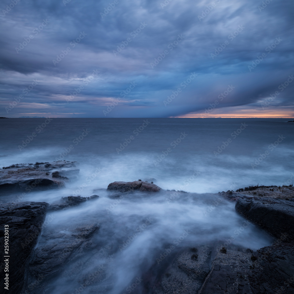 Dramatic clouds in sky over rugged coastline, ≈ I Lofoten, Moskenes¯y, Lofoten Islands, Norway Dramatic clouds in sky over rugged coastline, ≈ I Lofoten, Moskenes¯y, Lofoten Islands, Norway