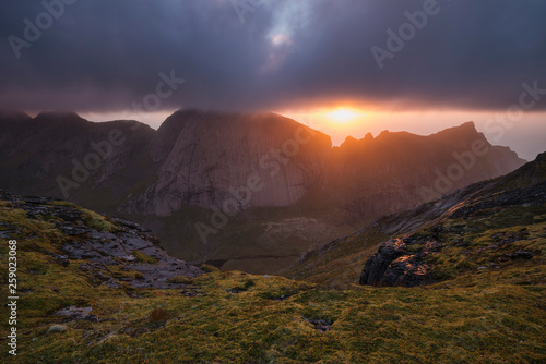 Evening sun breaks though clouds over mountains from the summit of Markan (602m), Moskenesøy, Lofoten Islands, Norway