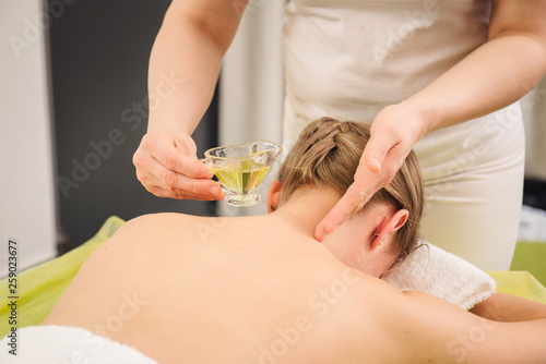 Woman having neck and shoulder massage in spa center