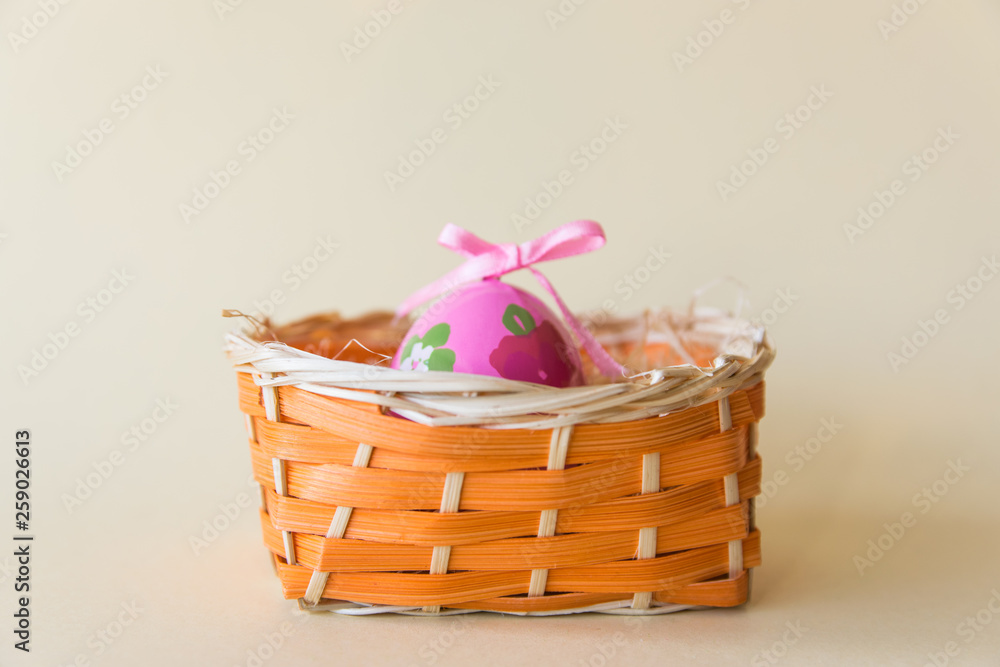 Pink easter egg in wicker basket. Pink easter egg in wicker basket.