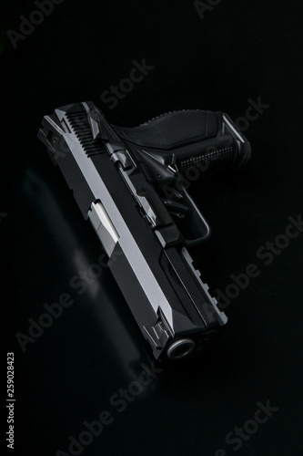 modern black gun on black back © solidmaks