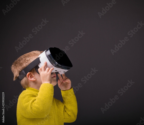 Boy with VR glasses on black background © cristovao31