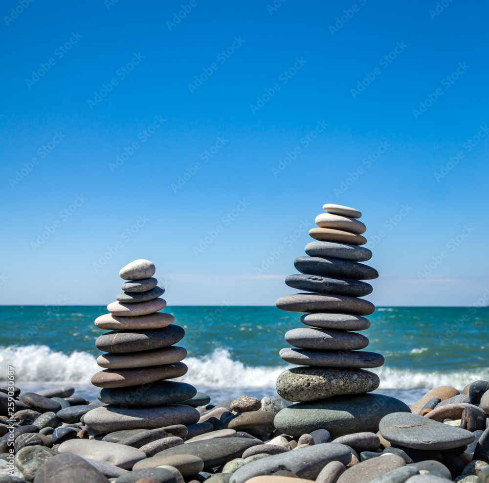 Two pyramids of stones for meditation lying on seacoast