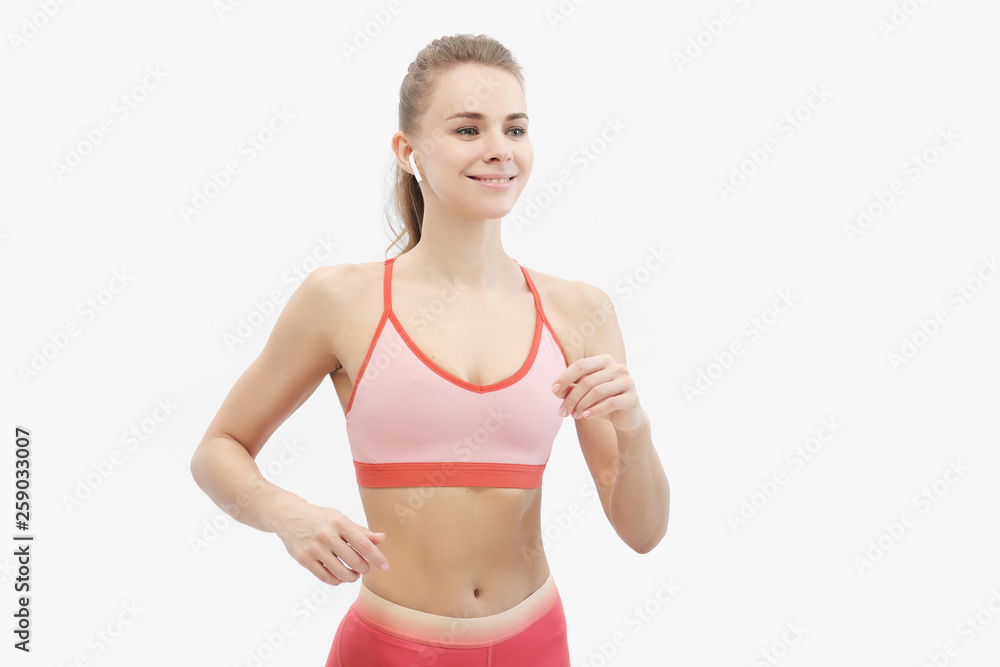 Sports blonde girl in red training clothes is engaged in jogging, in the studio on a white background. Sports blonde girl in red training clothes is engaged in jogging, in the studio on a white background.
