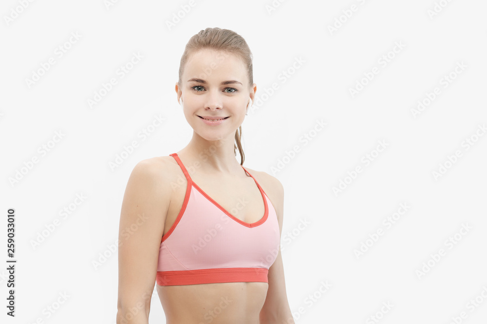 Sports blonde girl in red training clothes in the studio on a white background. Sports blonde girl in red training clothes in the studio on a white background.