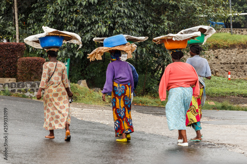 Group of Rwandan women in colorful traditionals clothes wearing washbowls on their heads, Kigali, Rwanda photo