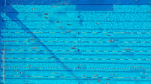 Obraz na plátně Aerial drone top view photo of open outdoor deep turquoise pool with swimmers pr