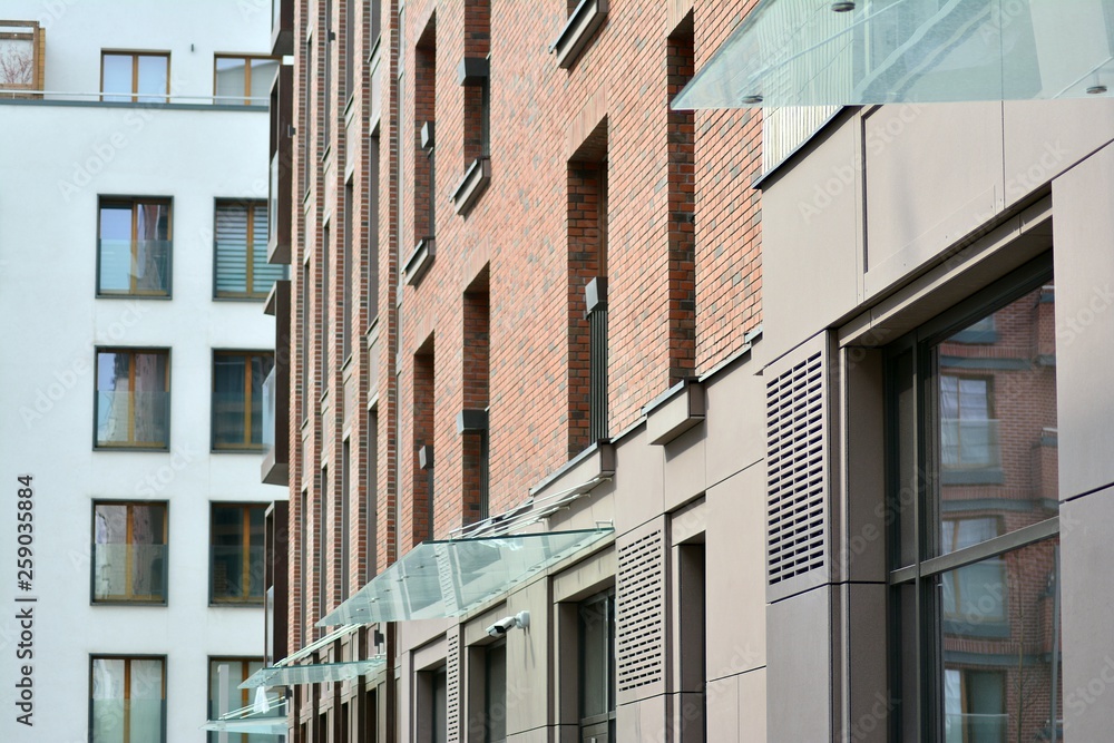 Naklejka premium Fragment of a modern apartment building in front. Very modern apartment house.