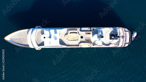 Aerial drone photo of luxury mega yacht docked in tropical open ocean sea