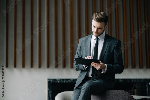 Stylish young man calling by the phone to solve business problems. Online consultation by phone. Freelancer discussing the development and planning of his online project. Outsourcing. Mobile services.