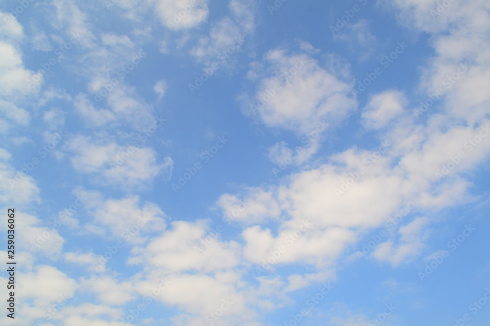 Blue sky background with white clouds. Holiday atmosphere. Sky