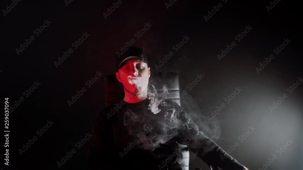 man in Black Suit vaping electronic cigarette makes smoke clouds man in Black Suit vaping electronic cigarette makes smoke clouds