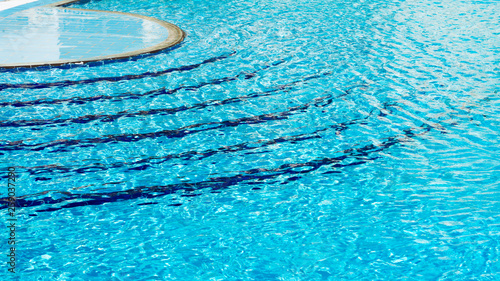 Blue steps stairway into swimming pool