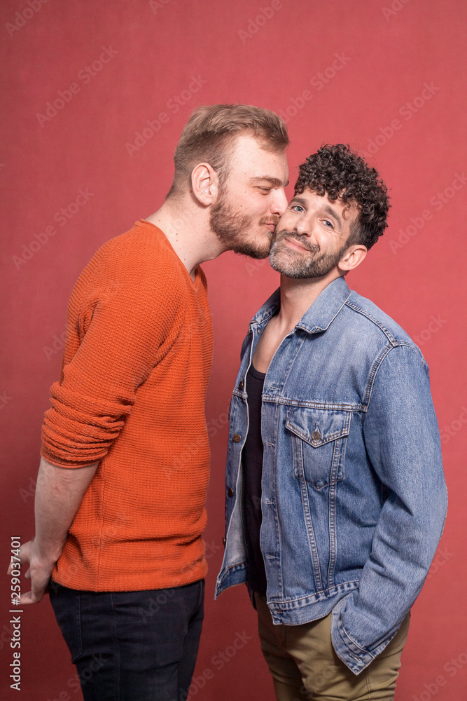 Obraz premium two men, gay couple intimate. kiss on cheek.
