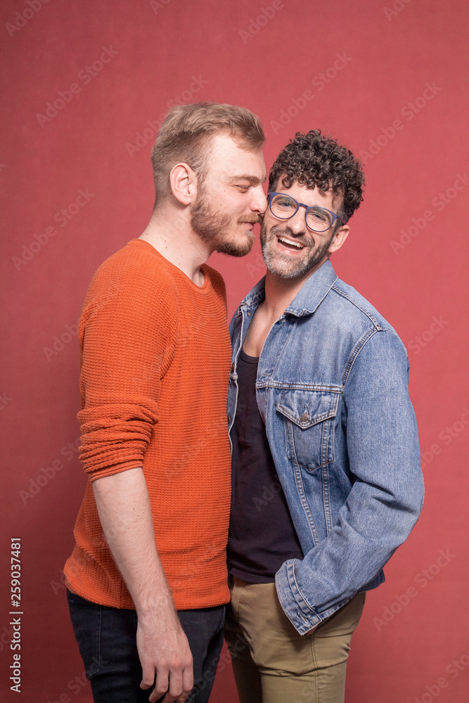 Obraz premium gay couple, intimate cuddling in front of camera.