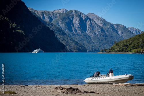 A boat and a ship traveling the lake