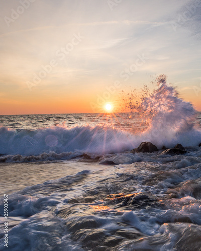 Waves crashing on the rocky shore at sunrise in Ocean City, MD. Photo by: Chuck Beyer photo
