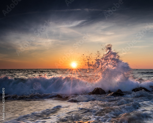 Crashing waves and colorful sky at sunrise in Ocean City, MD. Photo by: Chuck Beyer