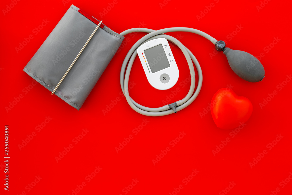 diagnostics of cardiac disease with pulsimeter on red background top view copyspace diagnostics of cardiac disease with pulsimeter on red background top view copyspace