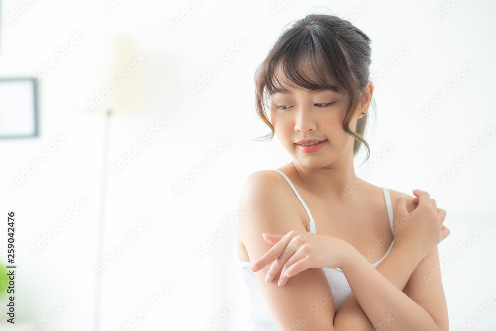Portrait of beautiful young asian woman makeup of cosmetic, girl hand touch shoulder and smile attractive, face of beauty perfect with wellness in the bedroom with skin care and healthcare concept. Portrait of beautiful young asian woman makeup of cosmetic, girl hand touch shoulder and smile attractive, face of beauty perfect with wellness in the bedroom with skin care and healthcare concept.