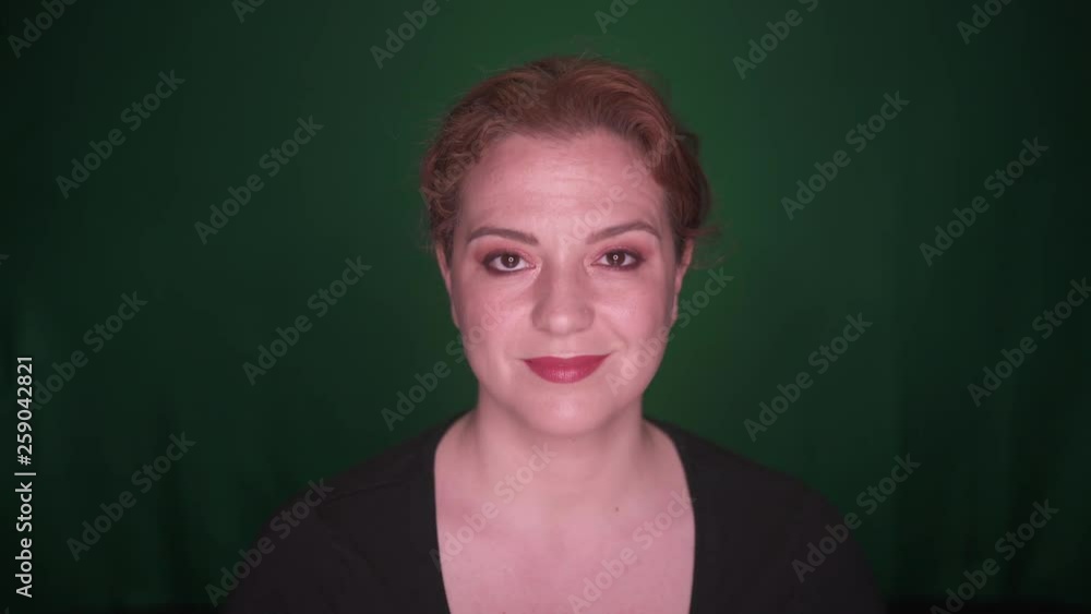 Positive Beautiful Woman Open eyes and Smiles, shot on Green Background Positive Beautiful Woman Open eyes and Smiles, shot on Green Background